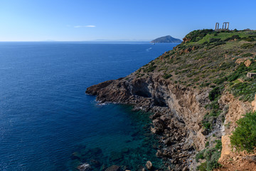 Beautiful rocky coastline and temple of Poseidon on Cape Sounion