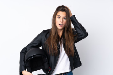 Young woman with a motorcycle helmet over isolated white background with surprise facial expression