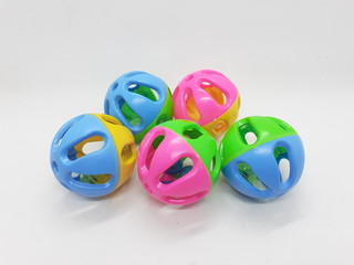 Various Colorful Cute Plastic Balls Design with Bells Ringer Sound Inside for Children or Pet Toys and Educational Purpose in White Isolated Background
