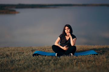 Fototapeta na wymiar Tired Bored Pregnant Woman Sitting on yoga Mat