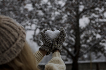 Snow heart woman hand