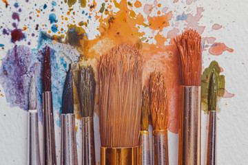 watercolor brushes on white paper