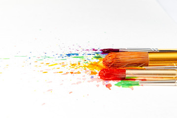 watercolor brushes on white paper