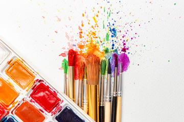 watercolor brushes on white paper