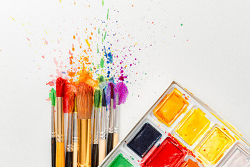 watercolor brushes on white paper