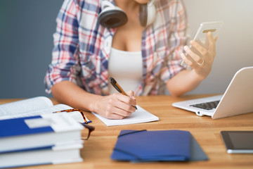 Midsection of female student learning at home