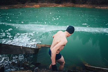 Man is going to swim in the ice hole. Winter swimming.