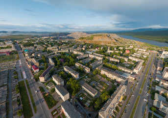 Aerial view of Satka city. Far away Karagai quarry and pond. Chellyabinsk region, Russia. Summer, sunny