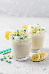 Vanilla whipped cream banana milk shake. Selective focus, copy space.