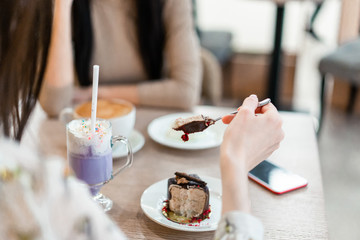 girl with brown cake and purple coffee