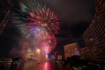 BANGKOK, THAILAND - 2020 JANUARY 1: New year countdown celebration fireworks along Chaophraya river, view from Taksin bridge in Bangkok, Thailand.