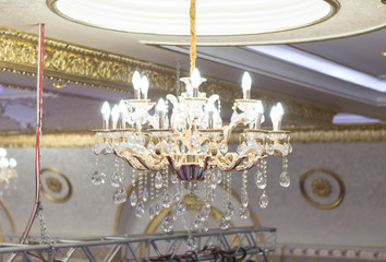 a large and beautiful chandelier hangs on the ceiling of the palace