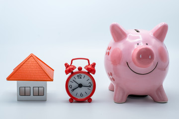 Coin ladder.Stacking coins on desk with clock. Finance and money concept.Stacked coins to save for the house with wooden table alarm clock, investment concept, finance, accounting and stock market.