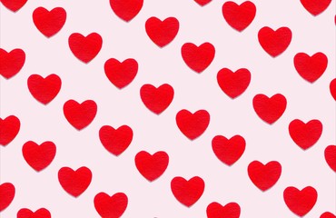 Seamless pattern of red small hearts on a  pink background. Photo collage, symbol of love, Valentine's day. Card, wrapping, greeting, culture, valentine, print.