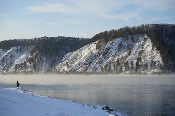 Winter fishing in Siberia on the banks of the Yenisei River in the Krasnoyarsk Territory, Russia