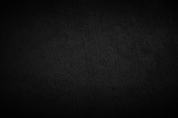 Dark black cement or concrete wall texture background.