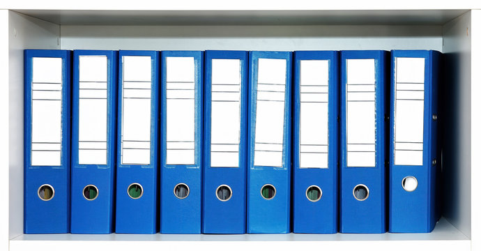 Blue file folders or binders in a row on the office shelf