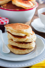 Homemade pancakes with apples on a wooden table, selective focus