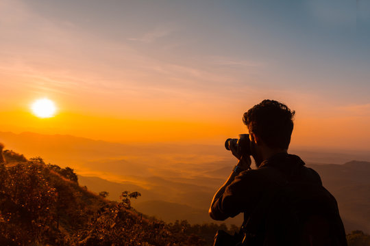 Photographer taking photo in the mountains during the sunrise, beautiful Nature landscape scenery shot from Palakkayam Thattu Kannur, Kerala Travel and Tourism Concept Image
