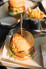 Close up of Tasty Burger with French fries on table. Fast food concept.