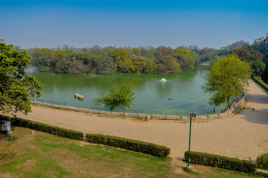 A mesmerizing view of hauz khas lake and garden from the hauz khas fort at hauz khas village at winter foggy morning.