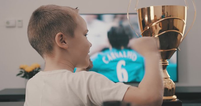Happy father and son watching football on tv. Bonding, Holidays, Sport, Family concept.