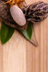 Top view macro shot of herbal pills and tablets arranged with spices on a red stone. Unani medicines concept.