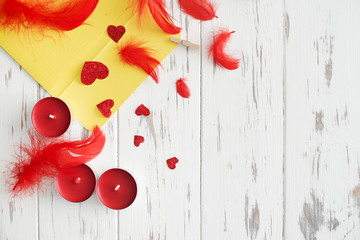 Valentine's Day background. hearts, gifts, candle, feathers, envelope in an envelope on a white wooden background. Valentines day concept. close up, top view, copy space