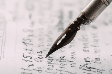 Fountain pen on an ancient handwritten letter. Old story. Retro style.