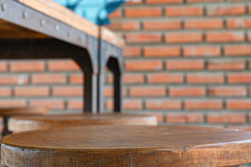 Empty wooden table for display of products in front of coffee shop abstract blur background