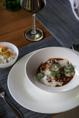 Classic beef stew with cream sauce and dill served with white rice aside	