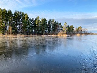 Thin ice on lake Seliger in warm winter. Russia, Tver region, Ostashkov city