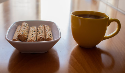 Cookies and a cup of tea on the wooden table