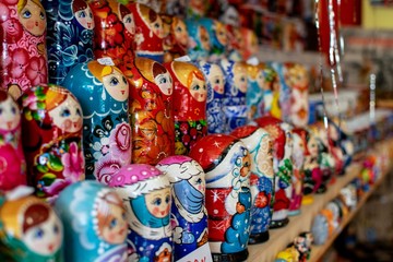 Babushkas traditional Russian dolls on a shelf in a tourist souvenir shop.