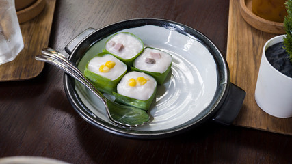 Famous Thai Pudding with Coconut topping on banana leaf(Tako) , Thai pudding with coconut topping, Thai dessert,Tako in white and black plate.