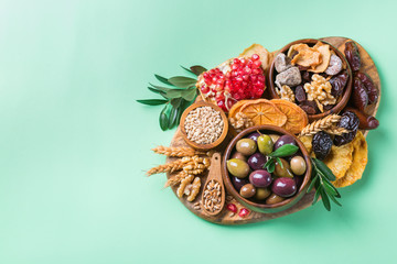 Tu Bishvat holiday symbols - dried fruits, pomegranate, barley, wheat