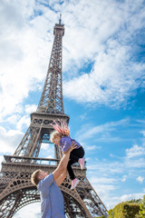 Family father and daughter happy and cheerful in Paris against the background of the Eiffel tower