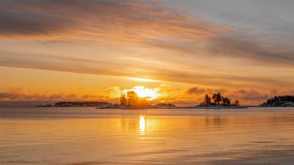 yellow winter sunrise with fog on Lake Ladoga, Republic of Karelia