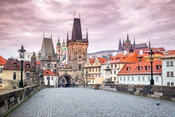 Lesser Town Bridge Tower at Charles Bridge in Prague with castle on background at sunrise, Czech Republic, Europe.
