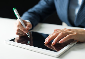 Man in business suit using tablet computer.