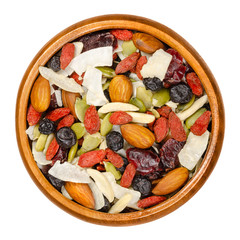 Superfood snacking mix in wooden bowl. Trail mix of dried almonds, cranberries, pepitas, coconut...