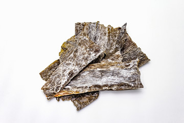 Dry laminaria japonica（kelp）Isolated on white background. Kombu seaweed, traditional Japanese ingredient for cooking Dashi soup.
