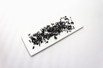 Dry wakame seaweed isolated on white background. Heap of dried kombu algae, traditional Japanese ingredient for cooking Dashi soup