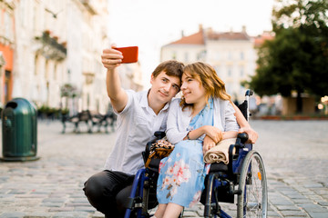 Happy couple in love taking selfie on the old city background - Disability concept with woman on...