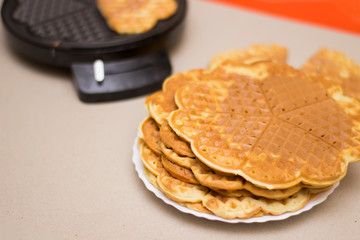 Fried waffles (pancakes) from above on a solid background