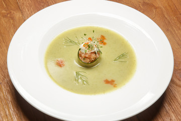 Chilled cucumber soup with salmon tartare. Exquisite dish. Creative restaurant meal concept.