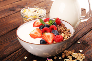 Tasty homemade granola served on table. Healthy breakfast with a bowl of oatmeal with banana, blueberries, strawberries and healthy food for Breakfast