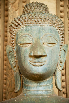 Head of an ancient Buddha statue located outside of the Hor Phra Keo temple (former temple of the Emerald Buddha) in Vientiane, Laos.