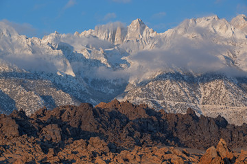 Winter landscape with fog shortly after sunrise of Mt. Whitney,, the Eastern Sierra Nevada Mountains and Alabama Hills near Lone Pine, California, USA