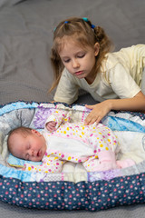 Sisters newborn and five years old